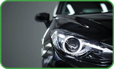 Black modern car closeup on black background 