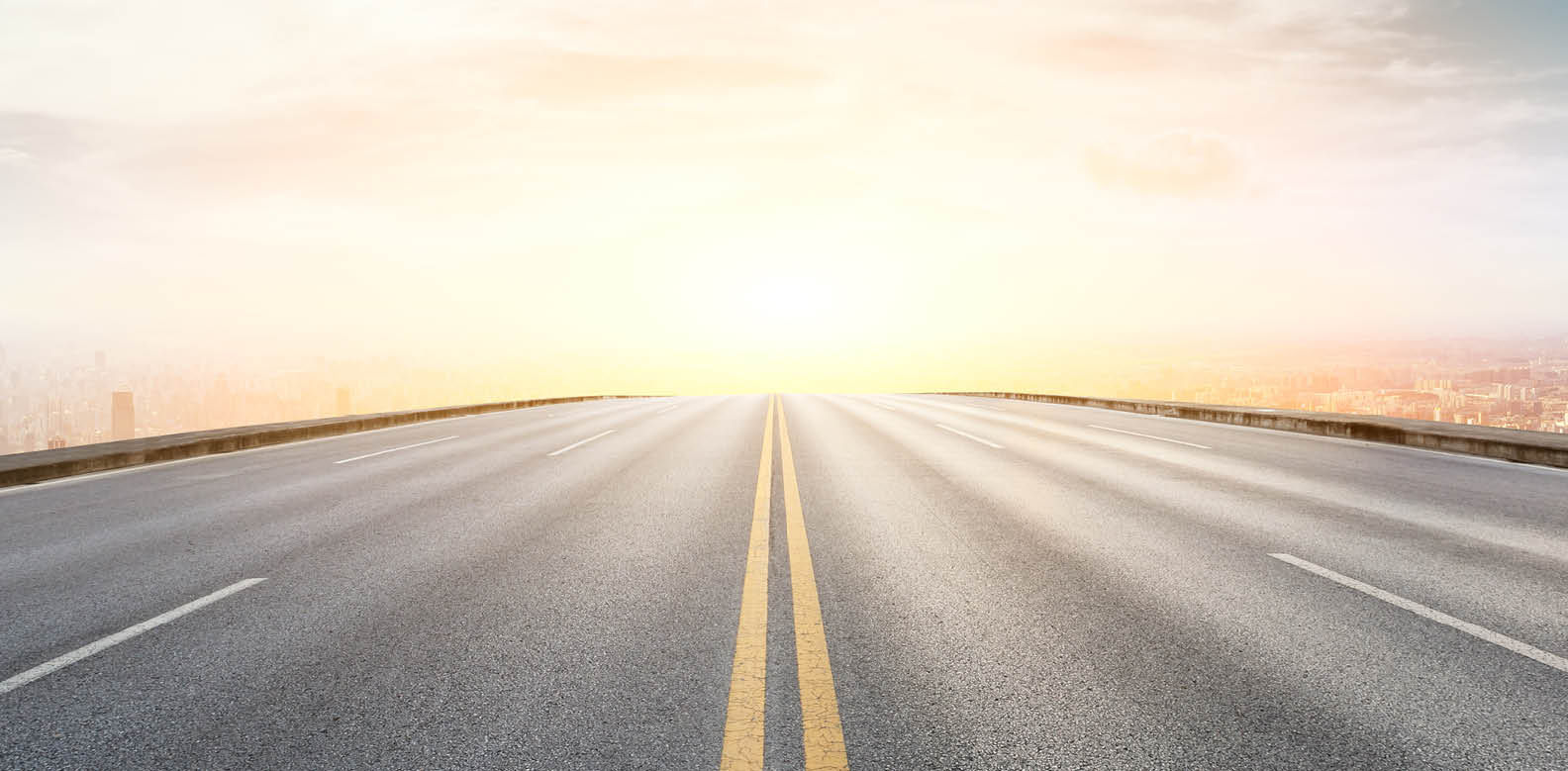 Panoramic city skyline and buildings with empty asphalt road at sunset